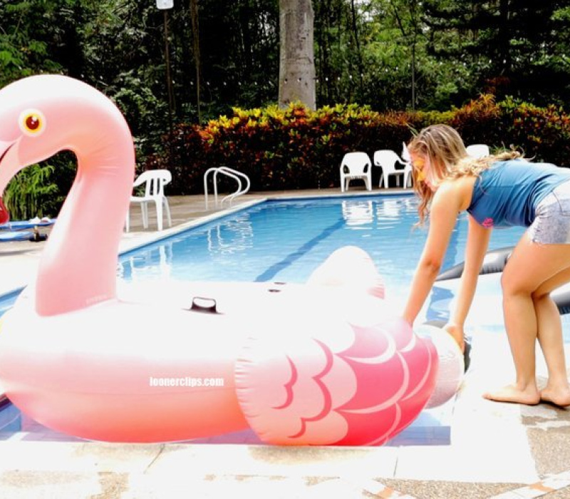 Alexis got wet on my flamingo in the pool