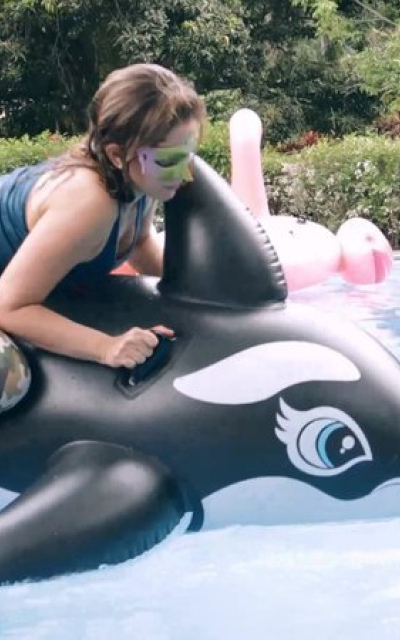 Alexis riding the wet whale in the pool