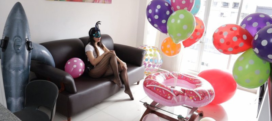 Cute Girl playing with an Inflatable Whale and Big balloons to sit2pop