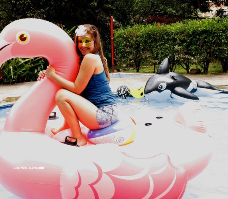 Alexis got wet on my flamingo in the pool