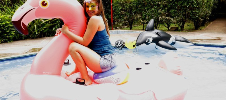 Alexis got wet on my flamingo in the pool
