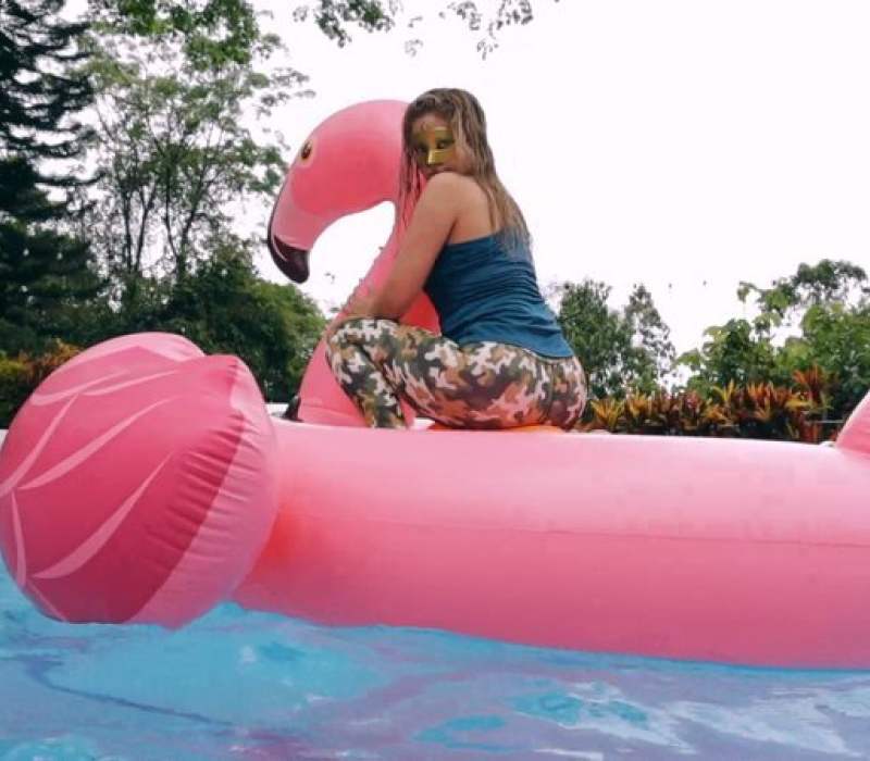 Alexis riding the wet whale in the pool